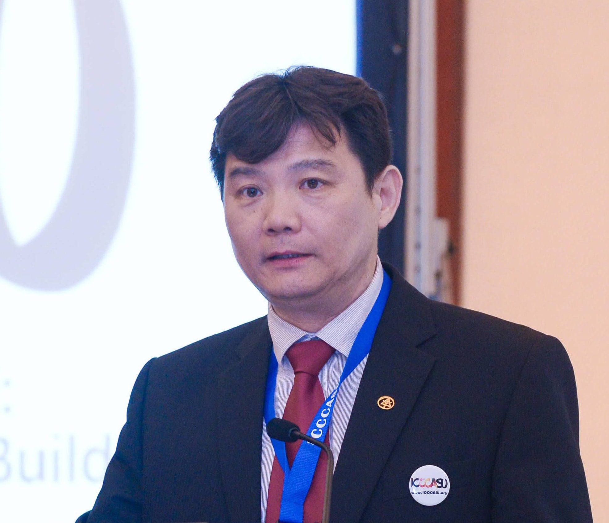 Professor Huhua Cao speaking at an ICCCASU conference